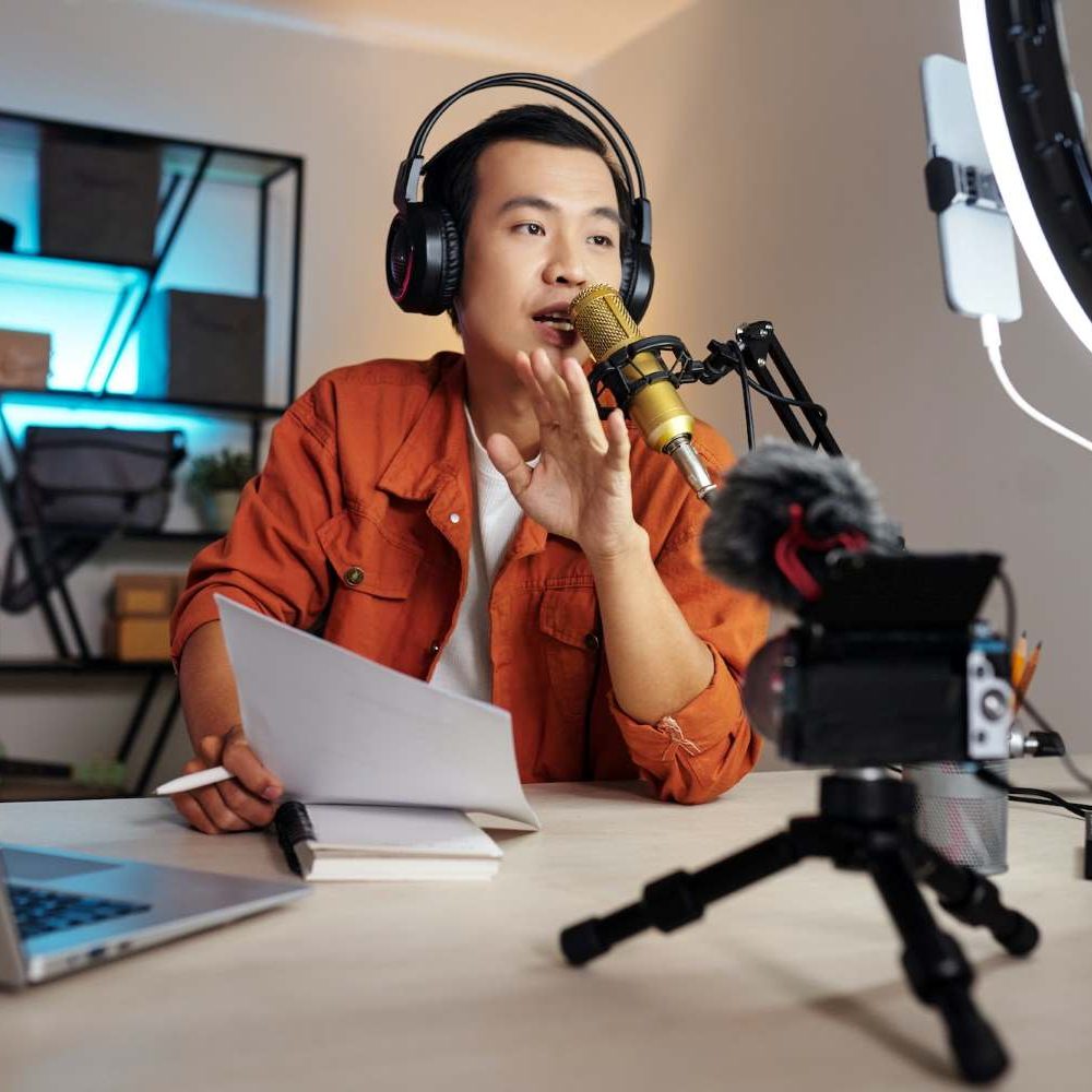 Male voiceover artist recording e-learning content with headphones